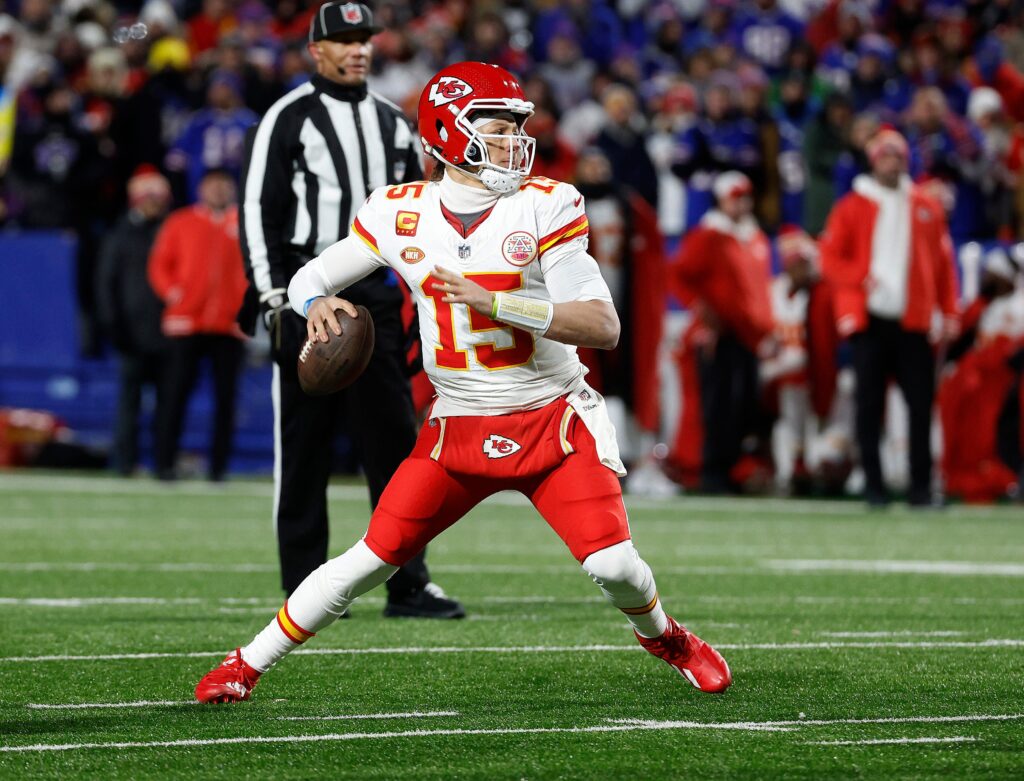 Patrick Mahomes (in an away uniform) looking to throw the ball close to the end zone