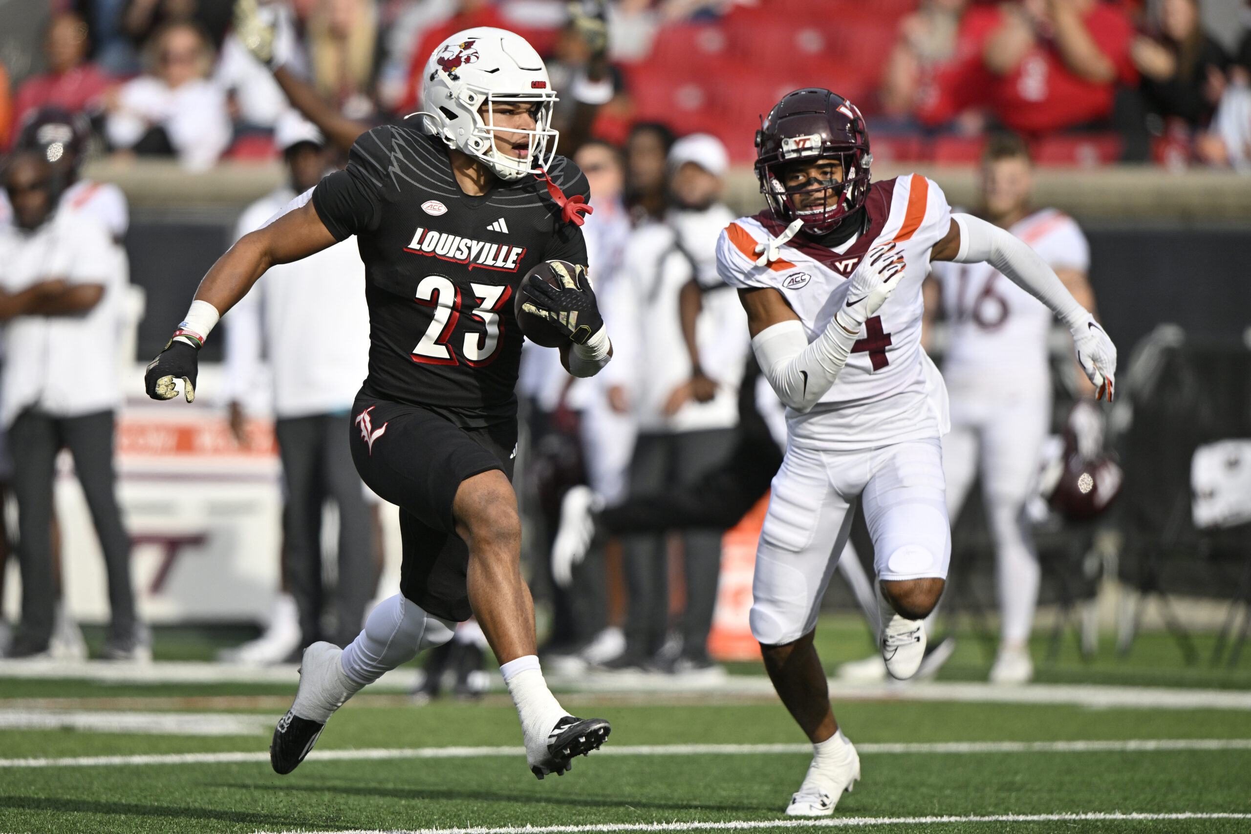 Louisville Cardinals running back Isaac Guerendo (23) runs the ball against Virginia Tech Hokies cornerback Mansoor Delane (4) during the first half.