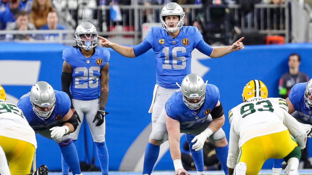 Detroit Lions quarterback Jared Goff stands at the line of scrimmage and talks to teammates before a play against the Green Bay Packers