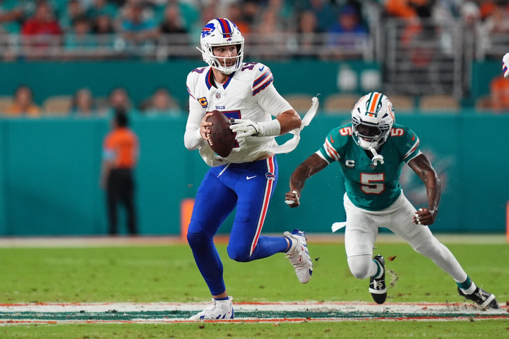 Buffalo Bills quarterback Josh Allen scrambles away from Miami Dolphins cornerback Jalen Ramsey during the first half at Hard Rock Stadium