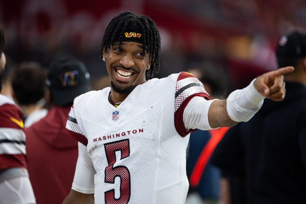 Washington Commanders quarterback Jayden Daniels (5) celebrates against the Arizona Cardinals at State Farm Stadium.