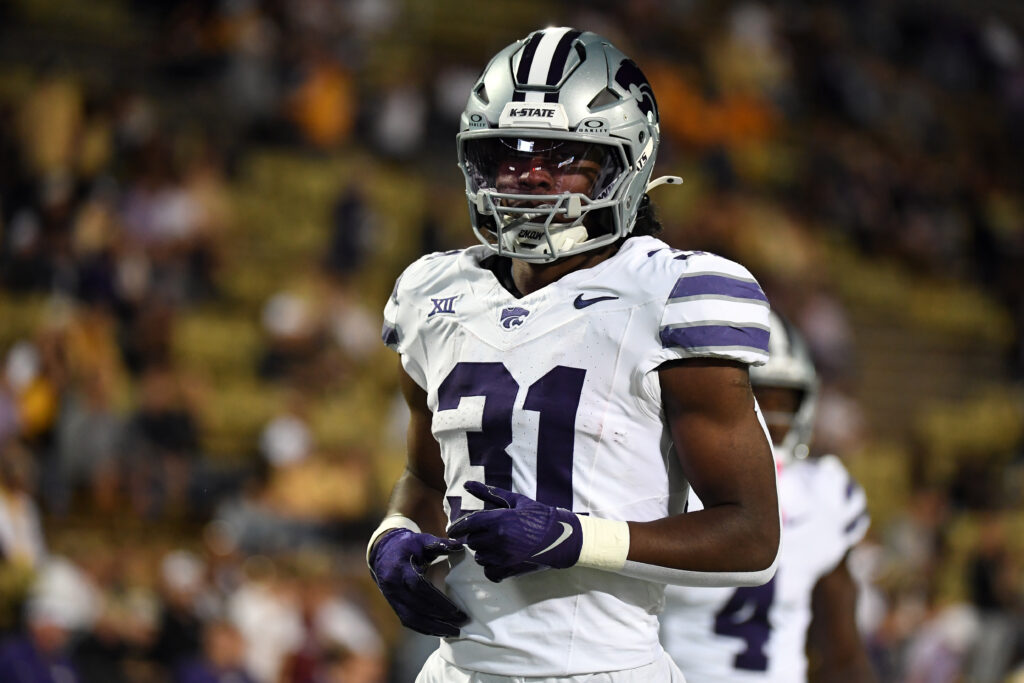 Kansas State Wildcats running back DJ Giddens warms up before the game against the Colorado Buffaloes at Folsom Field.