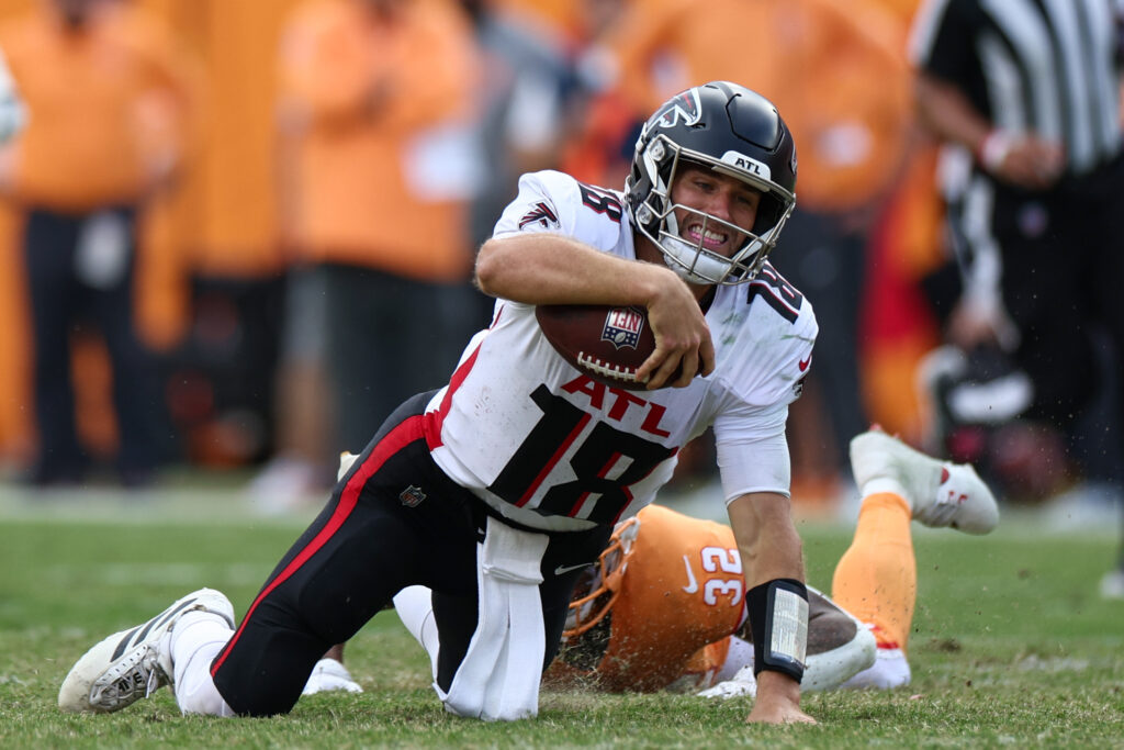 Atlanta Falcons quarterback Kirk Cousins being tackled by Tampa Bay Buccaneers safety Josh Hayes during a game at Raymond James Stadium in Tampa, Florida on October 27, 2024