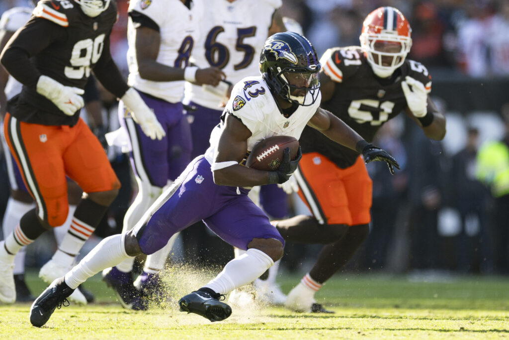 Baltimore Ravens running back Justice Hill runs the ball against the Cleveland Browns during the fourth quarter at Huntington Bank Field.