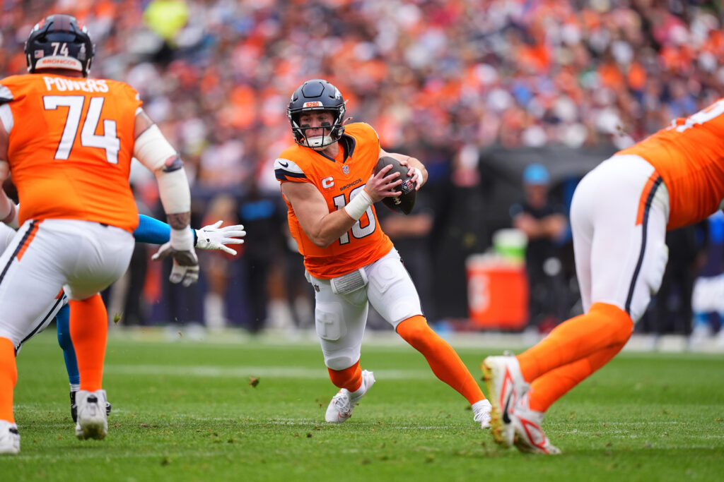 
Denver Broncos quarterback Bo Nix (10) scrambles with the ball in the first half against the Carolina Panthers at Empower Field at Mile High.