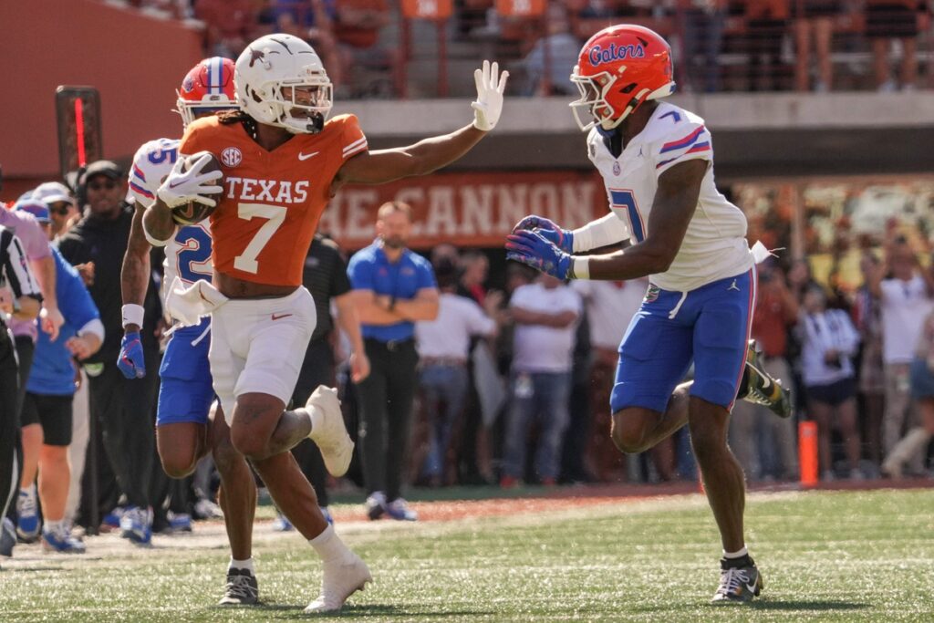 Texas Longhorns wide receiver Isaiah Bond advances the ball as Florida Gators defensive back Trikweze Bridges attempts to defend during college football game action at Darrell K. Royal Texas Memorial Stadium in Austin