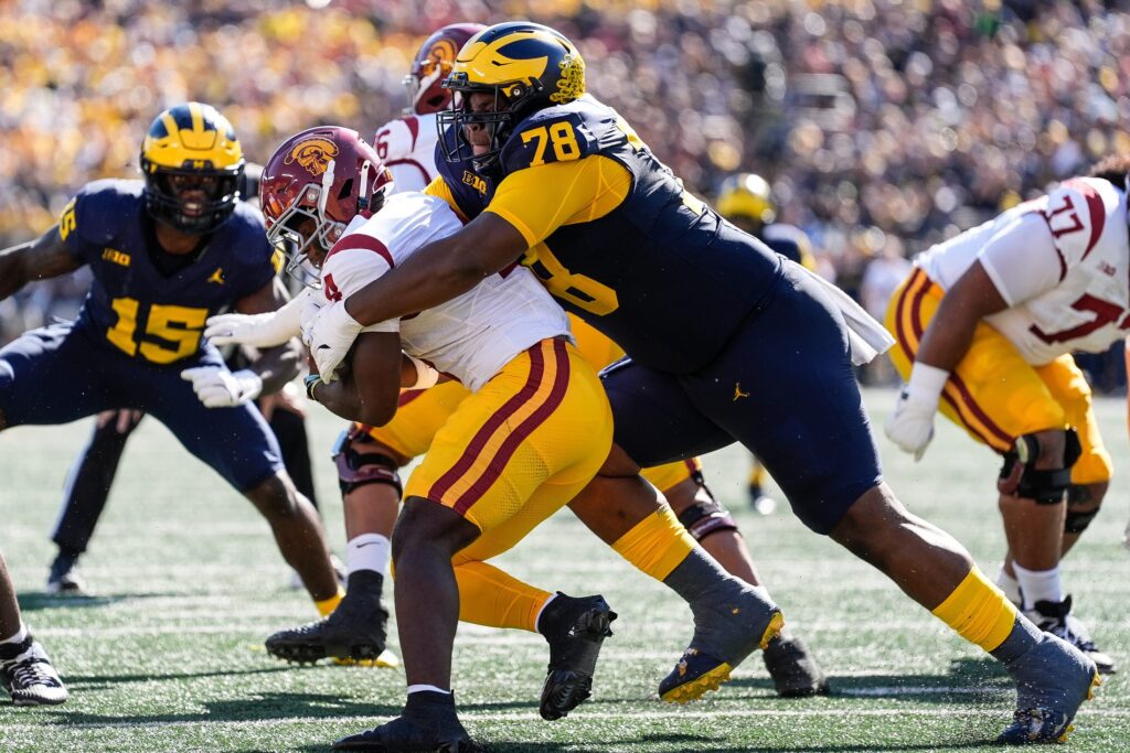 Michigan defensive lineman Kenneth Grant tackles USC running back Woody Marks during college football game action at Michigan Stadium in Ann Arbor