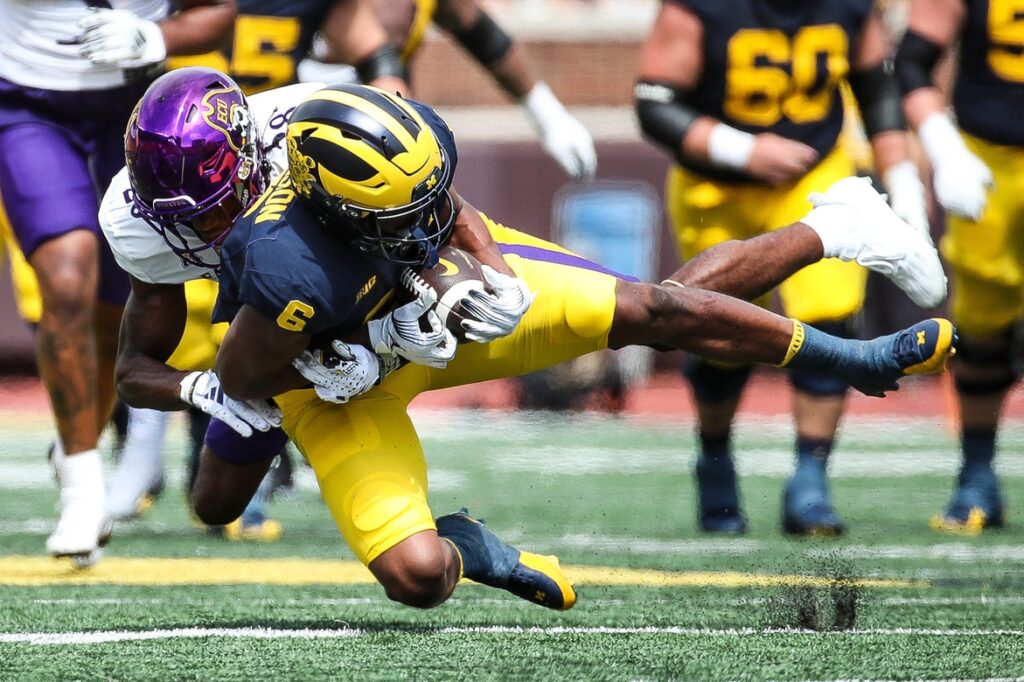 Michigan wide receiver Cornelius Johnson makes a catch against East Carolina defensive back Shavon Revel during college football game action at Michigan Stadium