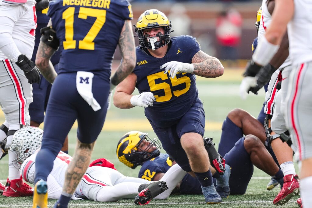 Michigan defensive lineman Mason Graham celebrates a tackle against Ohio State quarterback Kyle McCord during the second half at Michigan Stadium in Ann Arbor on Saturday, Nov. 25, 2023.