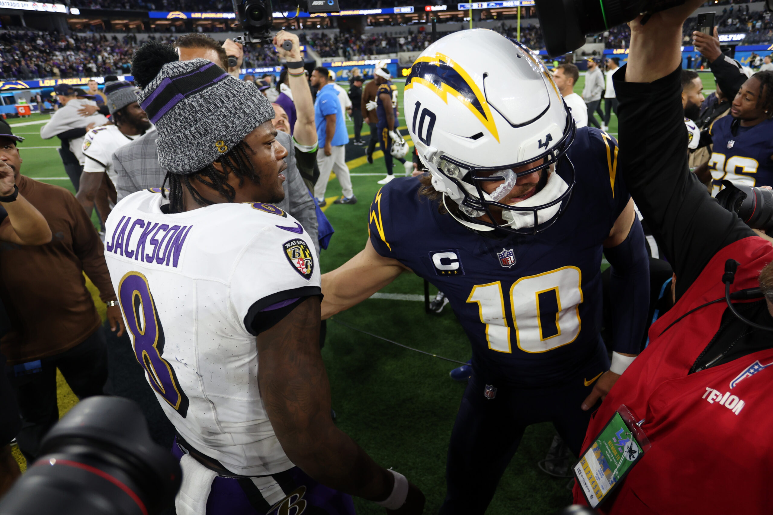 Baltimore Ravens quarterback Lamar Jackson (8) greets Los Angeles Chargers quarterback Justin Herbert (10) after defeating the Chargers.