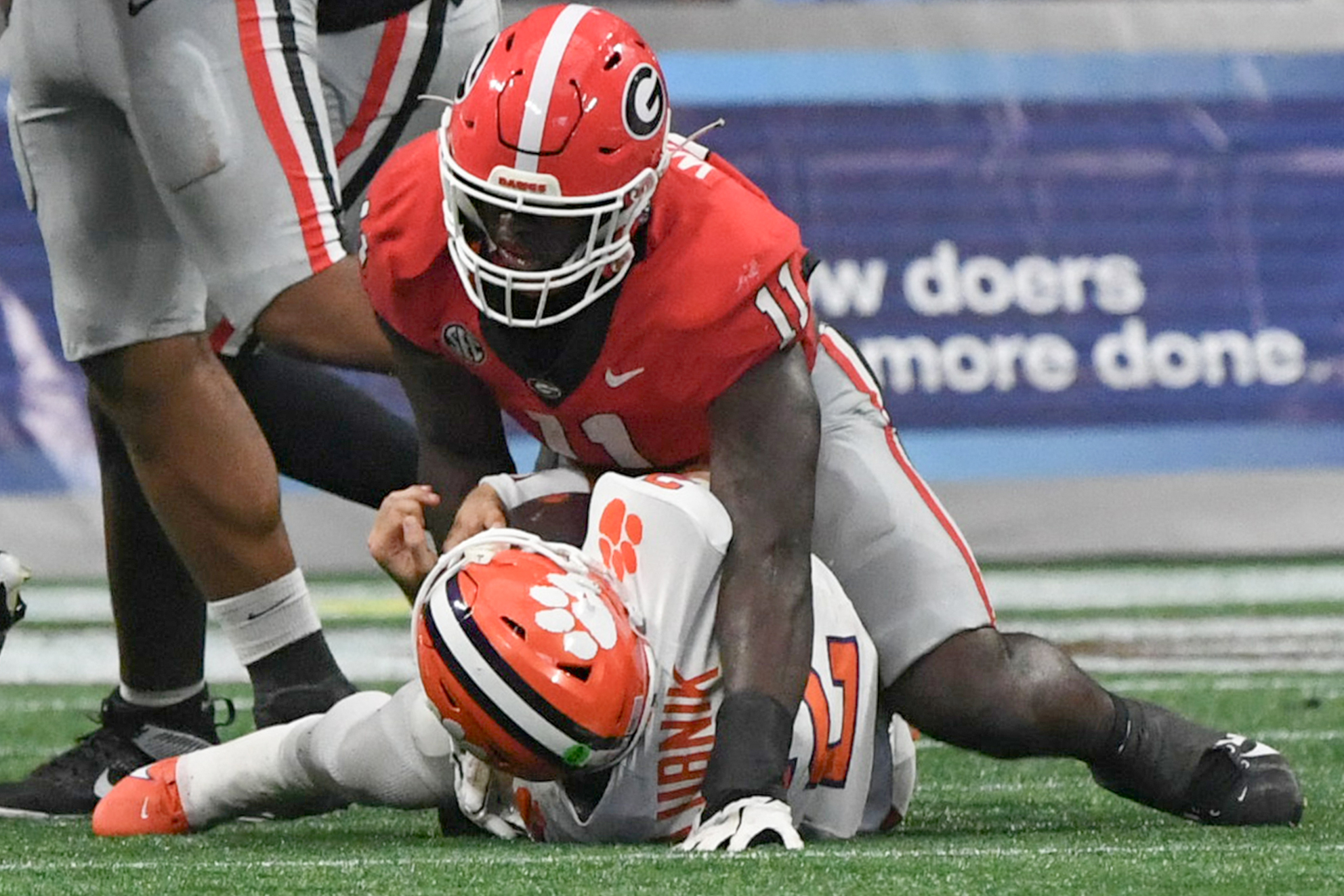 Georgia Bulldogs linebacker Jalon Walker (11) sacks Clemson Tigers quarterback Cade Klubnik (2) during the fourth quarter of the 2024 Aflac Kickoff Game at Mercedes-Benz Stadium.