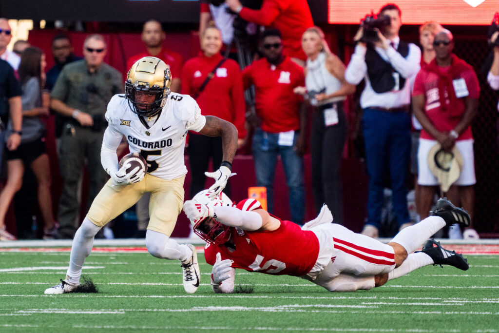 Colorado Buffaloes wide receiver Jimmy Horn Jr. (5) returns the opening kickoff against Nebraska Cornhuskers linebacker John Bullock (5) during the first quarter at Memorial Stadium.