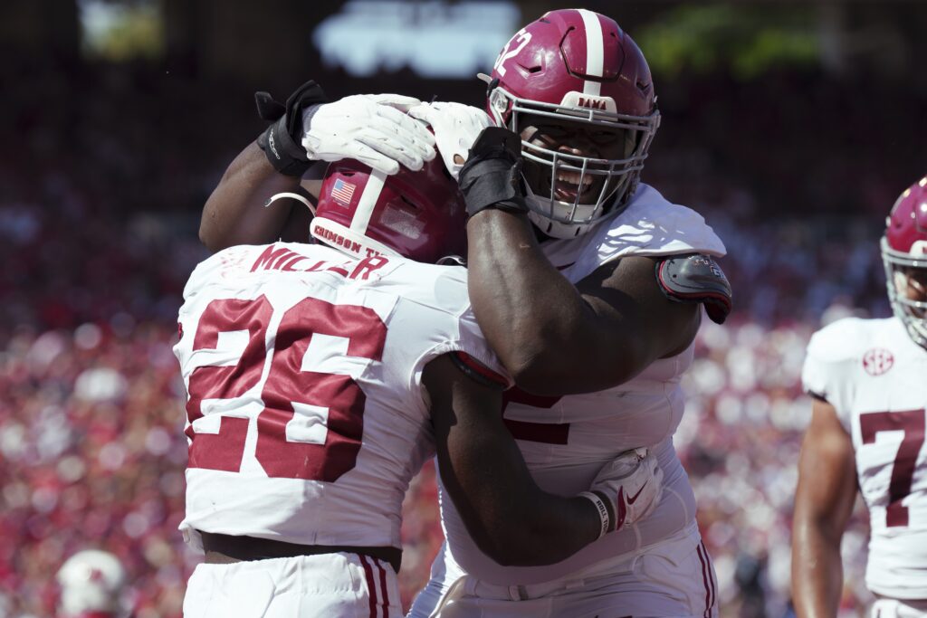 Sep 14, 2024; Madison, Wisconsin, USA; Alabama Crimson Tide running back Jam Miller (26) is greeted by offensive lineman Tyler Booker (52) after scoring a touchdown during the third quarter against the Wisconsin Badgers at Camp Randall Stadium. Mandatory Credit: Jeff Hanisch-Imagn Images