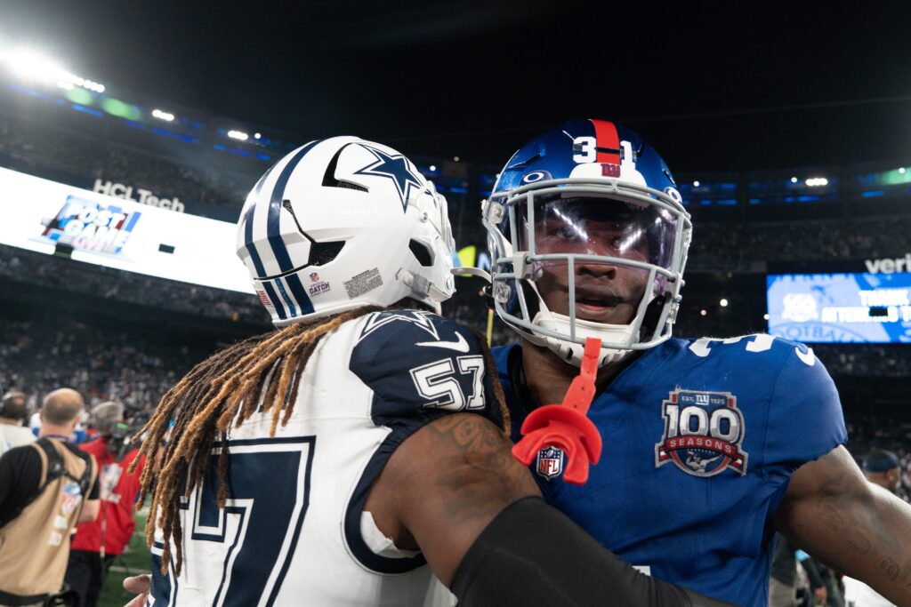 New York Giants safety Tyler Nubin (31) embraces Dallas Cowboys linebacker Buddy Johnson (57) following the end of the game at MetLife Stadium