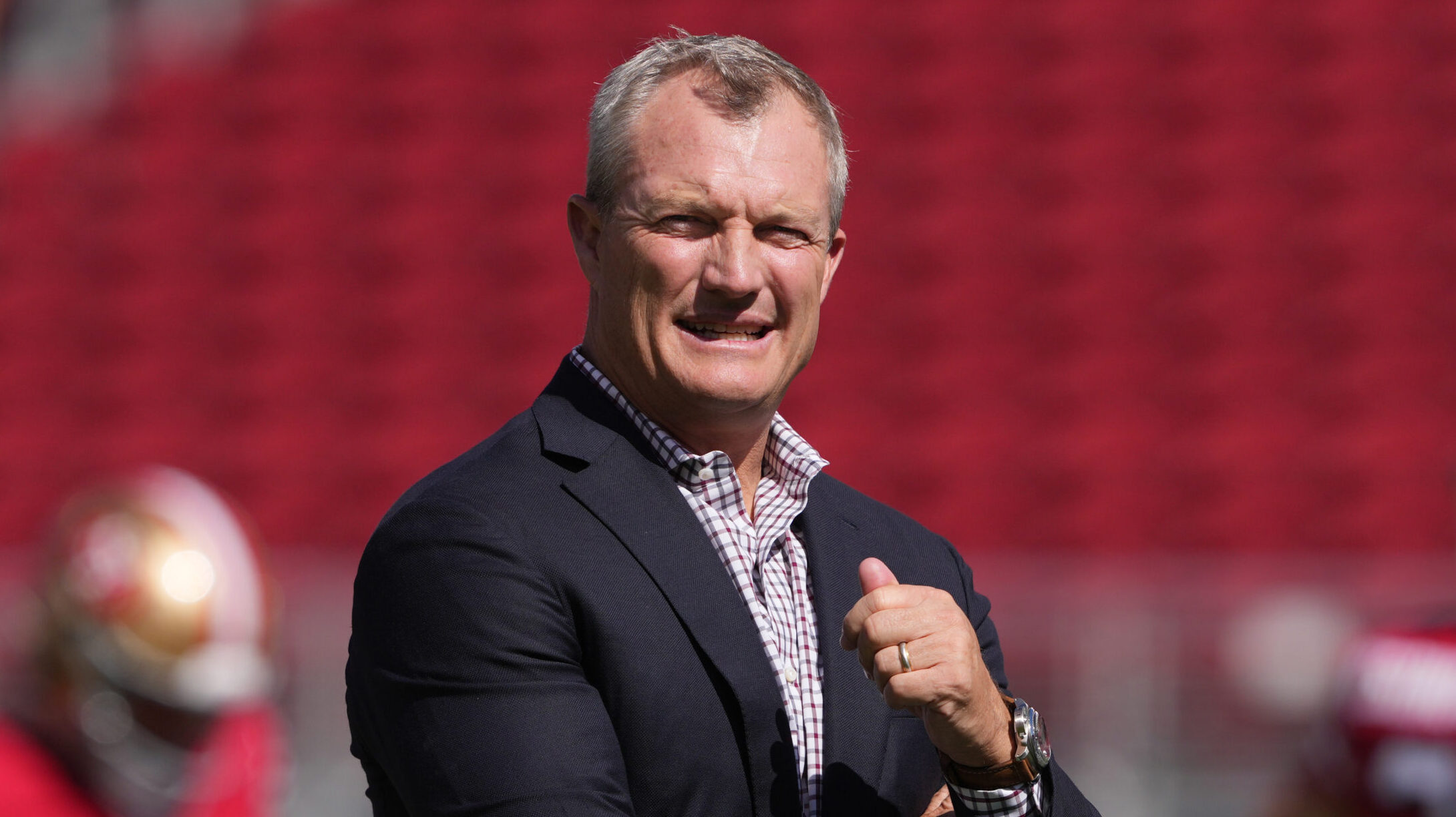 49ers GM John Lynch stands on the field before the game.