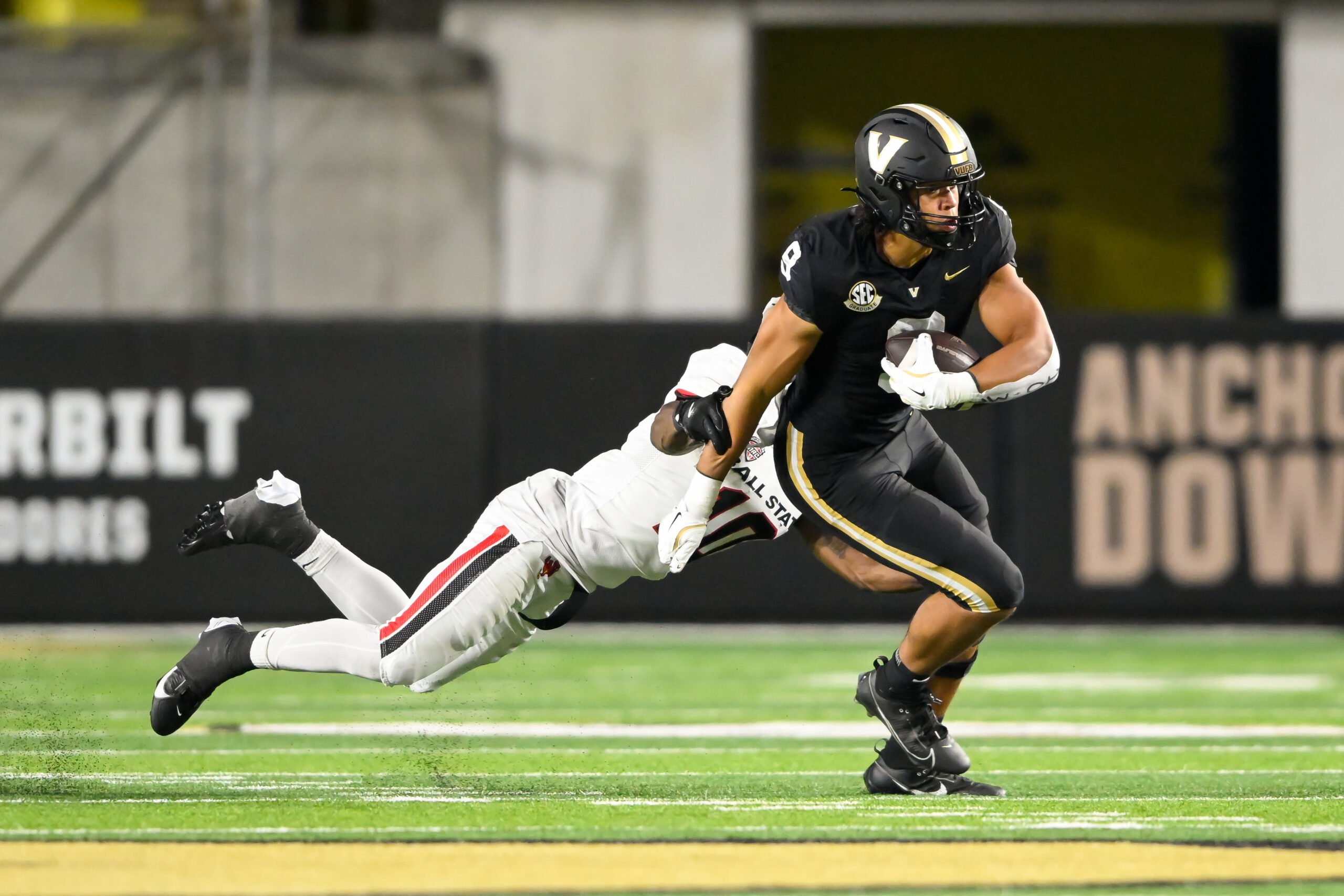 Vanderbilt Commodores tight end Eli Stowers (9) breaks the tackle of Ball State Cardinals defensive back George Udo (10 during the second half at FirstBank Stadium.