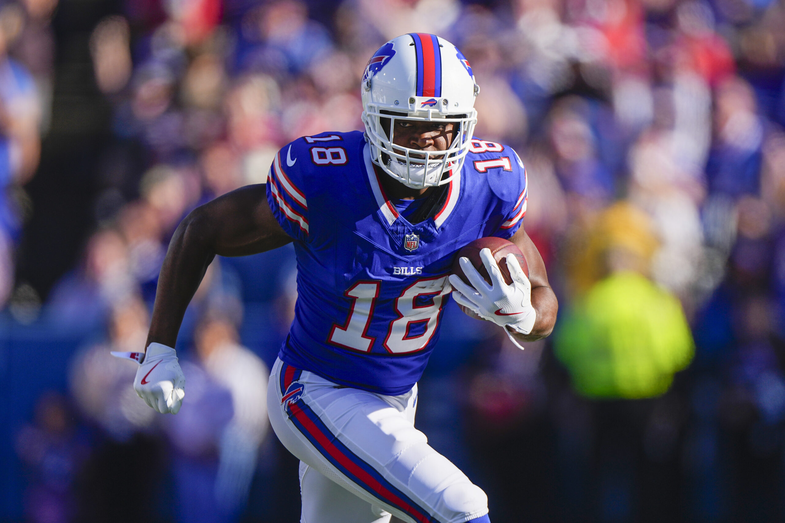 Buffalo Bills wide receiver Amari Cooper (18) runs with the ball after making a catch against the Tennessee Titans during the second half at Highmark Stadium.