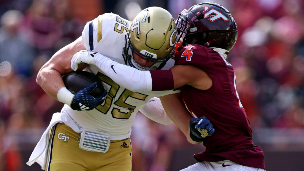 Georgia Tech Yellow Jackets tight end Jackson Hawes runs the ball after a catch against Virginia Tech Hokies cornerback Mansoor Delane during the first quarter at Lane Stadium.