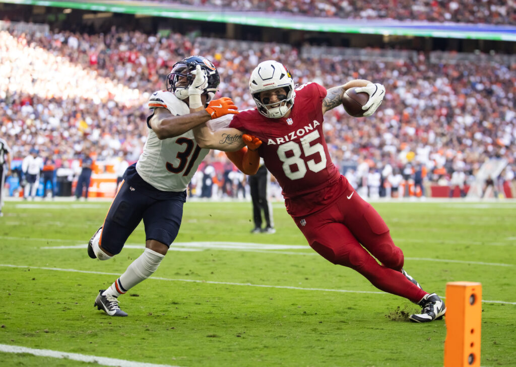 Arizona Cardinals tight end Trey McBride scores a touchdown against Chicago Bears safety Kevin Byard III in the first half at State Farm Stadium.