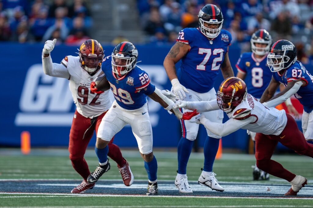 New York Giants running back Tyrone Tracy Jr. breaks a tackle from Washington Commanders cornerback Noah Igbinoghene at MetLife Stadium in East Rutherford on Sunday, Nov. 3, 2024.