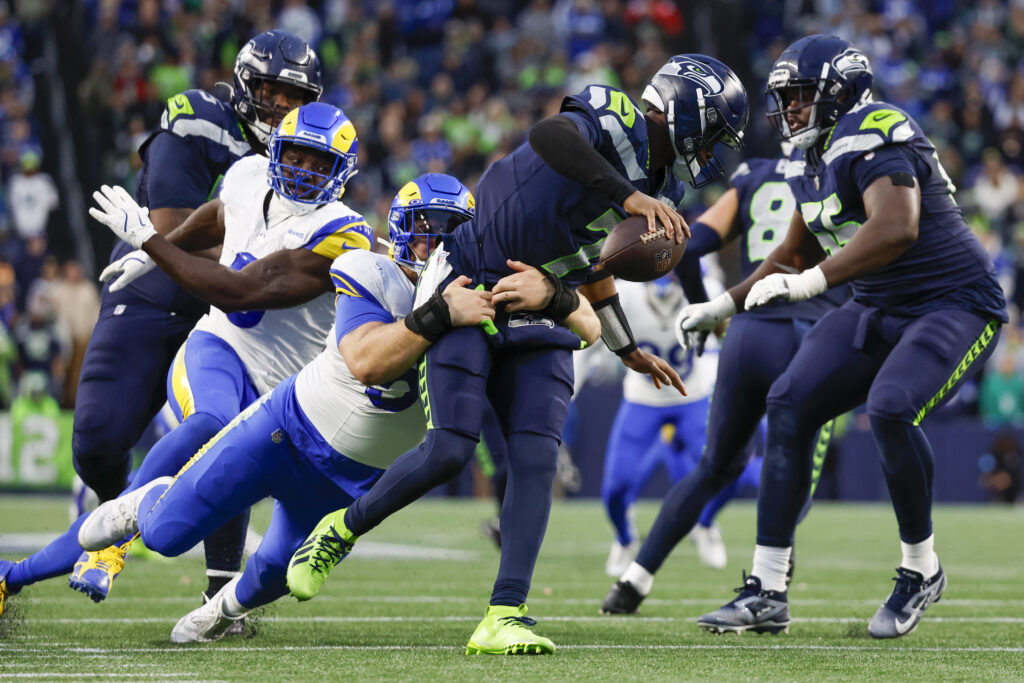 Los Angeles Rams defensive tackle Braden Fiske sacks Seattle Seahawks quarterback Geno Smith (7) during the fourth quarter at Lumen Field.