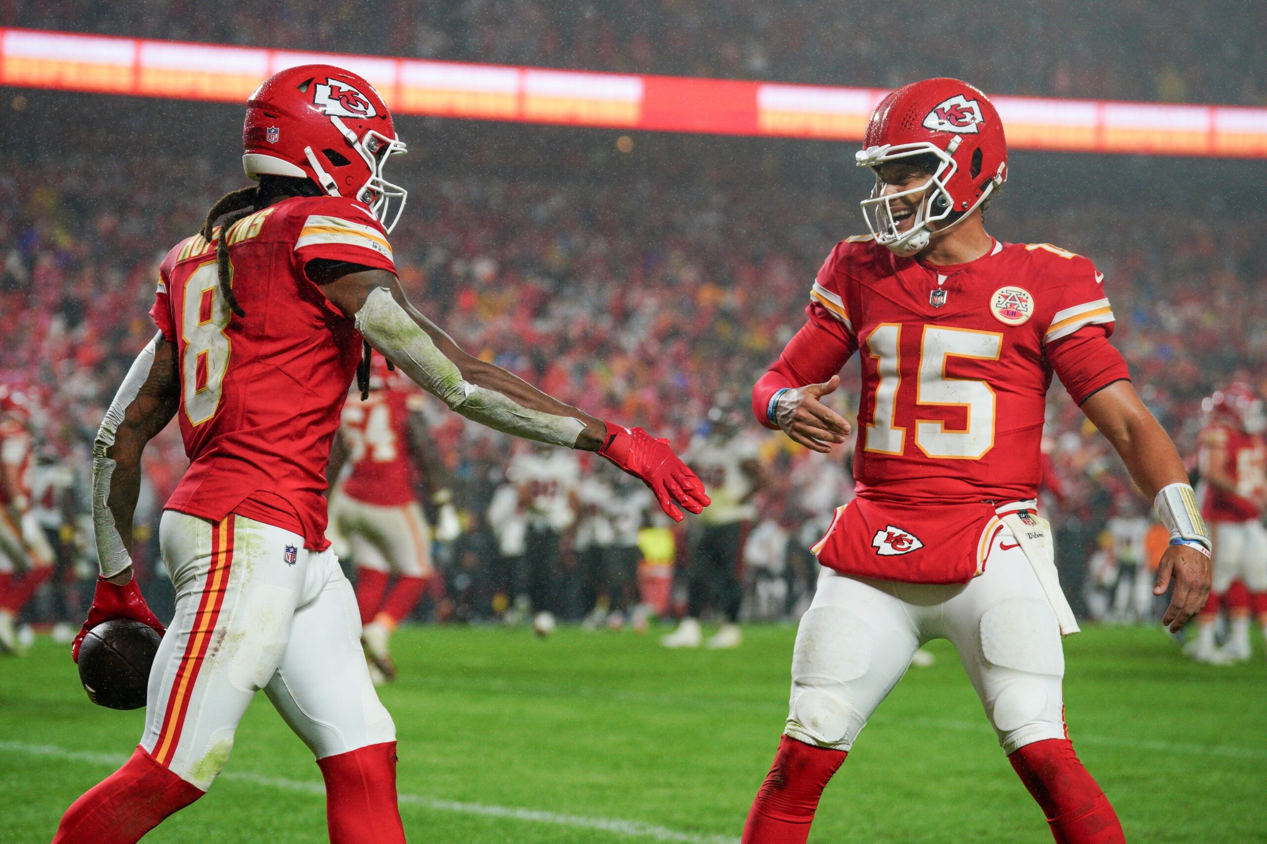 Kansas City Chiefs wide receiver DeAndre Hopkins (8) celebrates with quarterback Patrick Mahomes (15) after scoring against the Tampa Bay Buccaneers during the second half at GEHA Field at Arrowhead Stadium