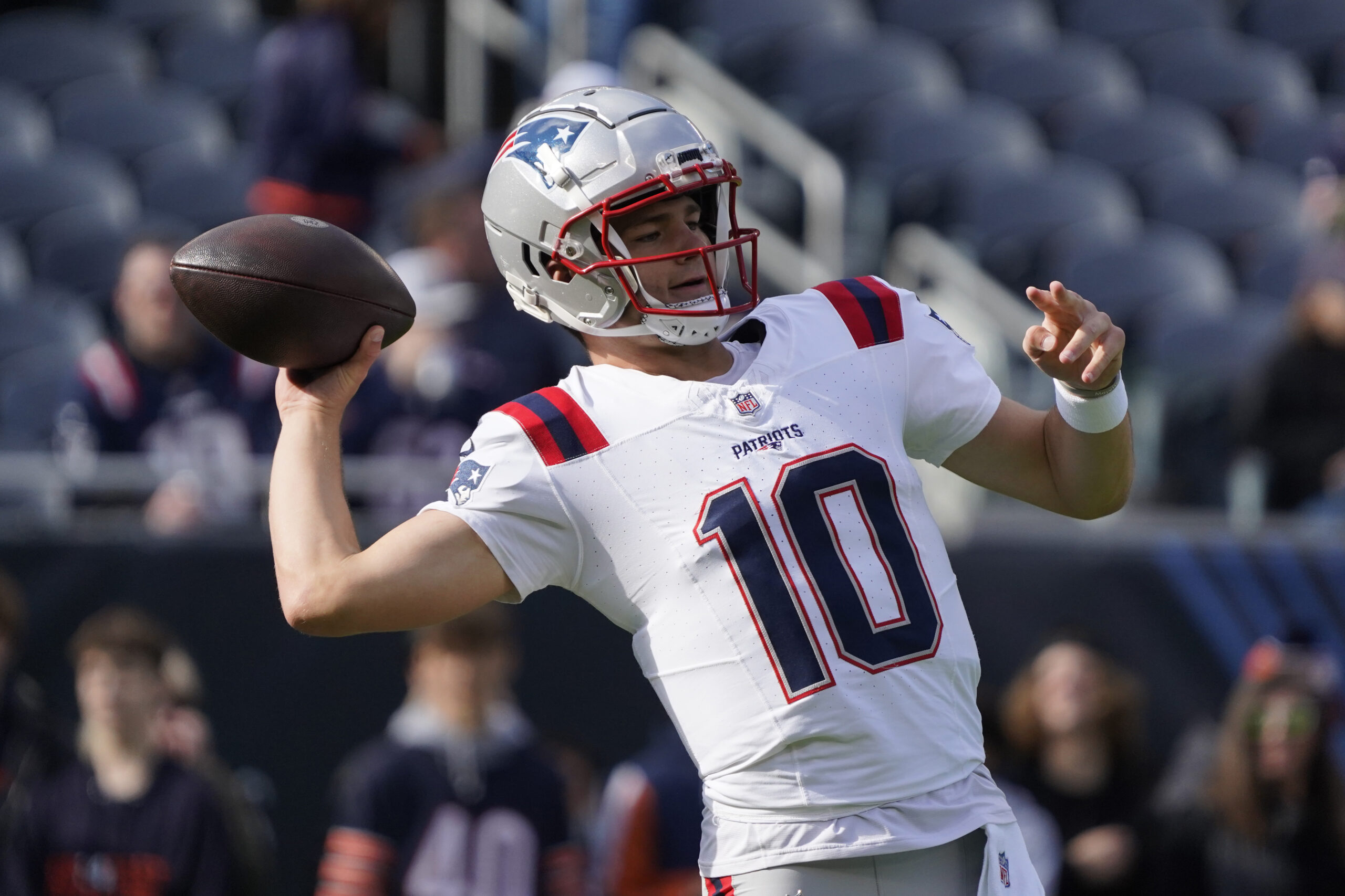 New England Patriots quarterback Drake Maye (10) warms up before the game against the Chicago Bears at Soldier Field.