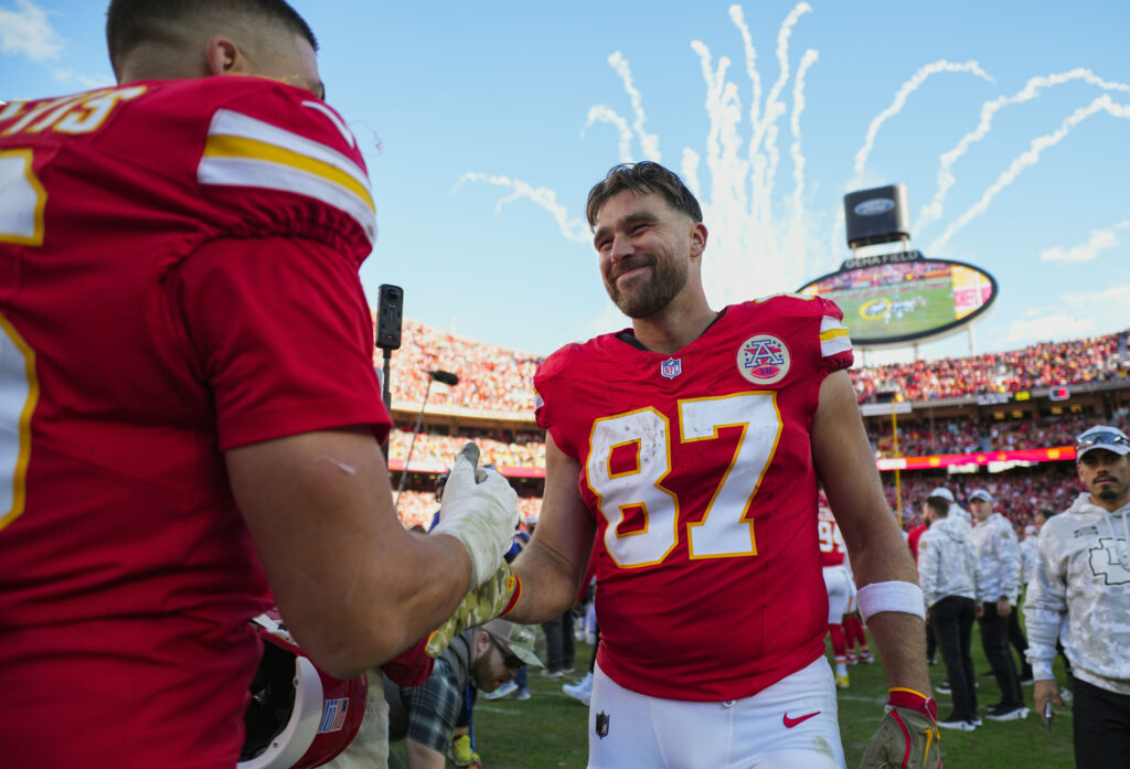 Kansas City Chiefs tight end Travis Kelce celebrates with defensive end George Karlaftis after defeating the Denver Broncos at GEHA Field at Arrowhead Stadium