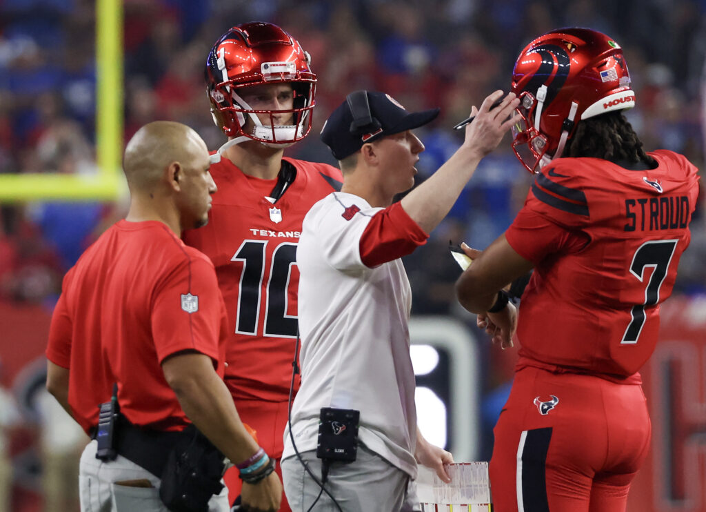 Houston Texans quarterback C.J. Stroud talks with offensive coordinator Bobby Slowik during a Detroit Lions timeout in the first quarter at NRG Stadium. 