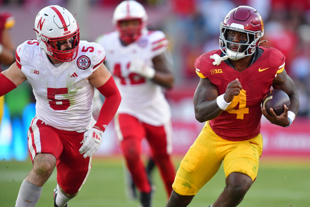 Southern California Trojans running back Woody Marks (4) runs the ball ahead of Nebraska Cornhuskers linebacker John Bullock (5) during the second half at the Los Angeles Memorial Coliseum.