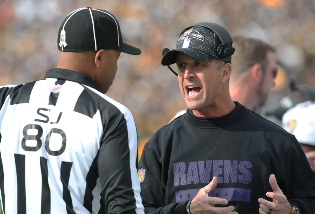 Baltimore Ravens head coach John Harbaugh talks with side judge Alonzo Ramsey II against the Pittsburgh Steelers during the first quarter at Acrisure Stadium. 