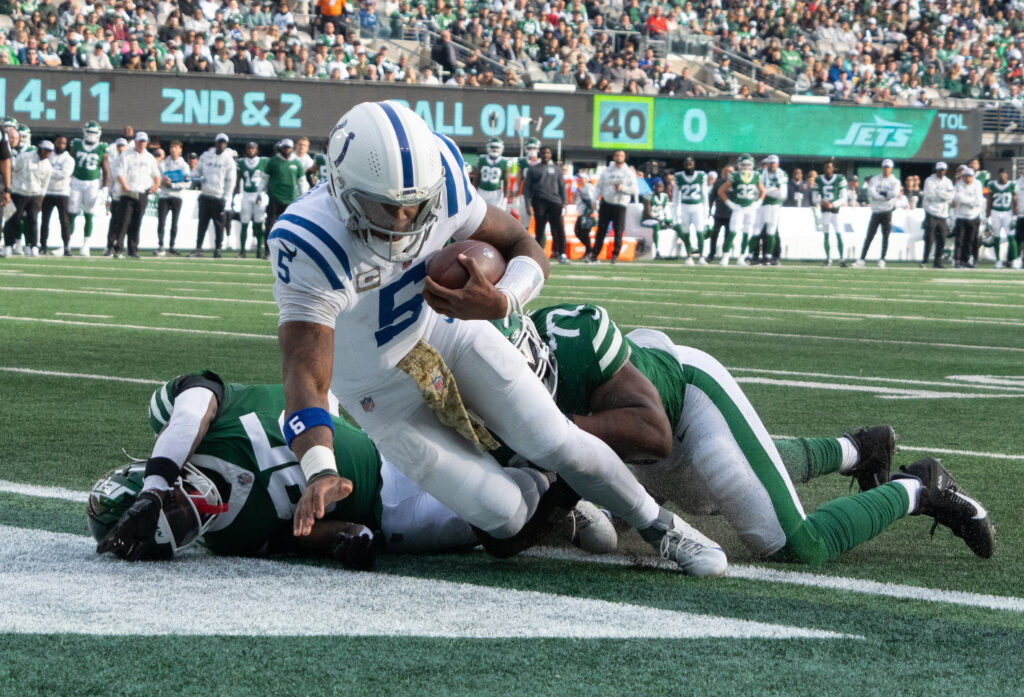 Indianapolis Colts quarterback Anthony Richardson (5) scores a touchdown over New York Jets safety Jalen Mills (35) and defensive end Micheal Clemons in the first half at MetLife Stadium.