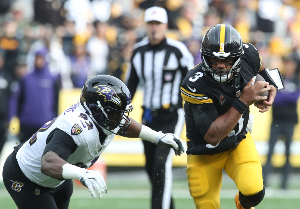 Pittsburgh Steelers quarterback Russell Wilson (3) carries the ball against Baltimore Ravens defensive tackle Nnamdi Madubuike (92) during the second quarter at Acrisure Stadium.