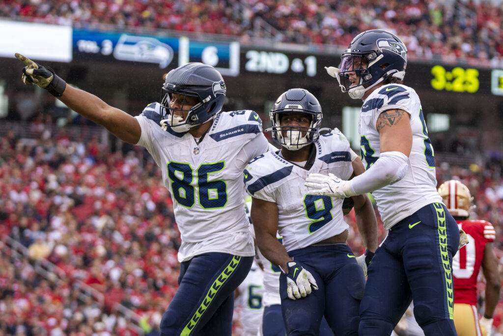 Seattle Seahawks running back Kenneth Walker III (9) is congratulated by tight end Pharaoh Brown (86) and tight end AJ Barner (88) for scoring a touchdown against the San Francisco 49ers during the third quarter.