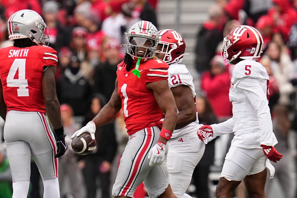 Ohio State Buckeyes running back Quinshon Judkins (1) smiles at Indiana Hoosiers defensive back D'Angelo Ponds (5) after a run during the first half of the NCAA football game at Ohio Stadium in Columbus