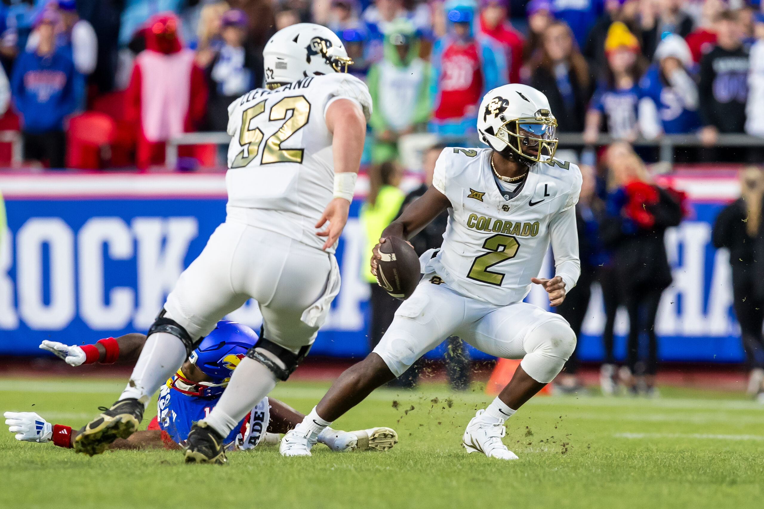 Colorado quarterback Shedeur Sanders (2) attempts to avoid a sack during the 3rd quarter game between the Kansas Jayhawks and the Colorado Buffaloes at GEHA Field at Arrowhead Stadium.