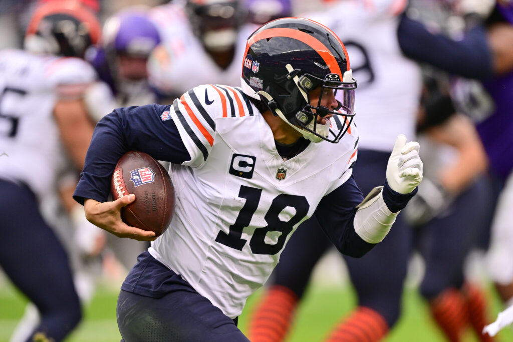 Chicago Bears quarterback Caleb Williams (18) runs the ball against the Minnesota Vikings during the fourth quarter at Soldier Field.