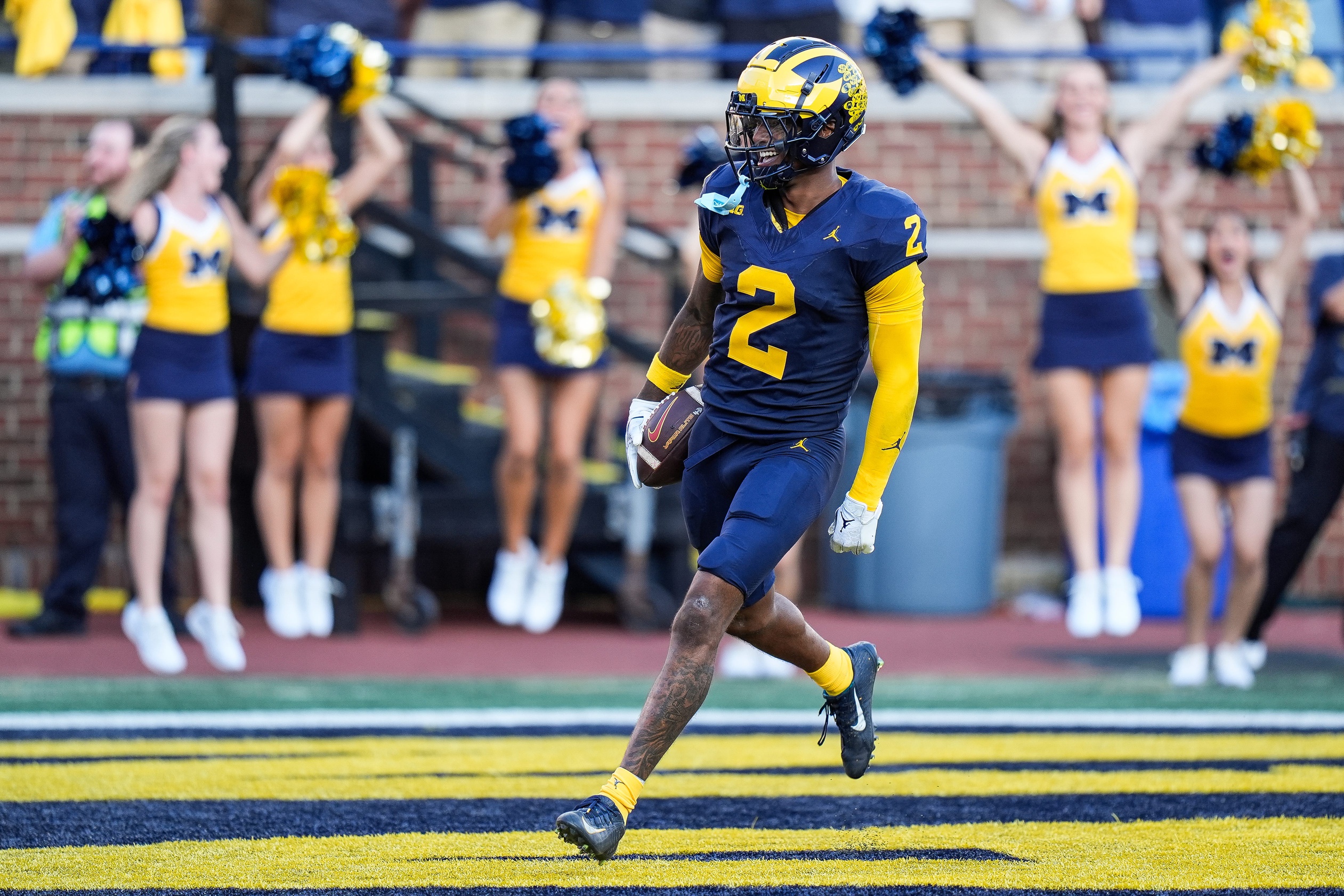 Michigan defensive back Will Johnson celebrates a touchdown after intercepting USC quarterback Miller Moss during the second half in college football game action at Michigan Stadium in Ann Arbor