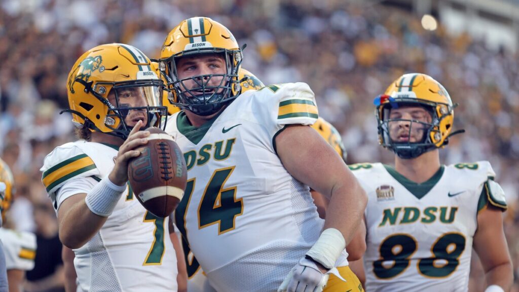 North Dakota State tackle Grey Zabel congratulates teammate Cam Miller on a touchdown at Folsom Field in Boulder, Colorado, on Thursday, August 29, 2024.David Samson / The Forum