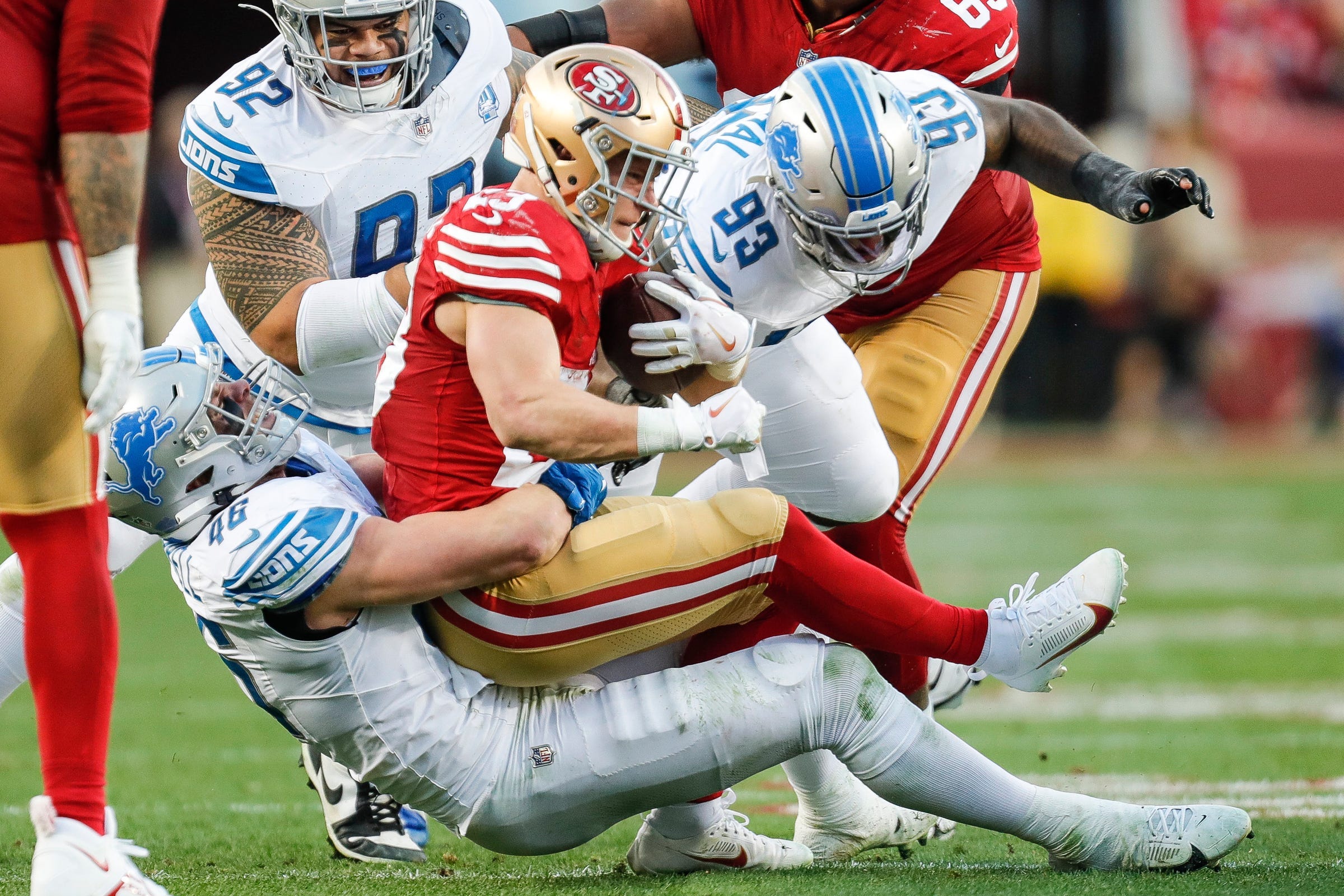 Lions linebacker Jack Campbell tackles 49ers running back Christian McCaffrey during the first half of the NFC championship game at Levi's Stadium in Santa Clara.