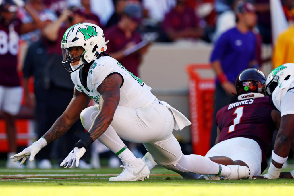 Marshall Thundering Herd defensive lineman Mike Green (15) celebrates after sacking Virginia Tech Hokies quarterback Kyron Drones (1) during the first quarter at Lane Stadium. 