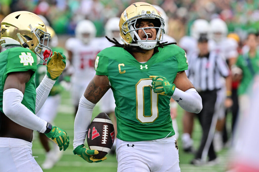 Notre Dame Fighting Irish safety Xavier Watts (0) celebrates after an interception against the Louisville Cardinals in the second quarter at Notre Dame Stadium.