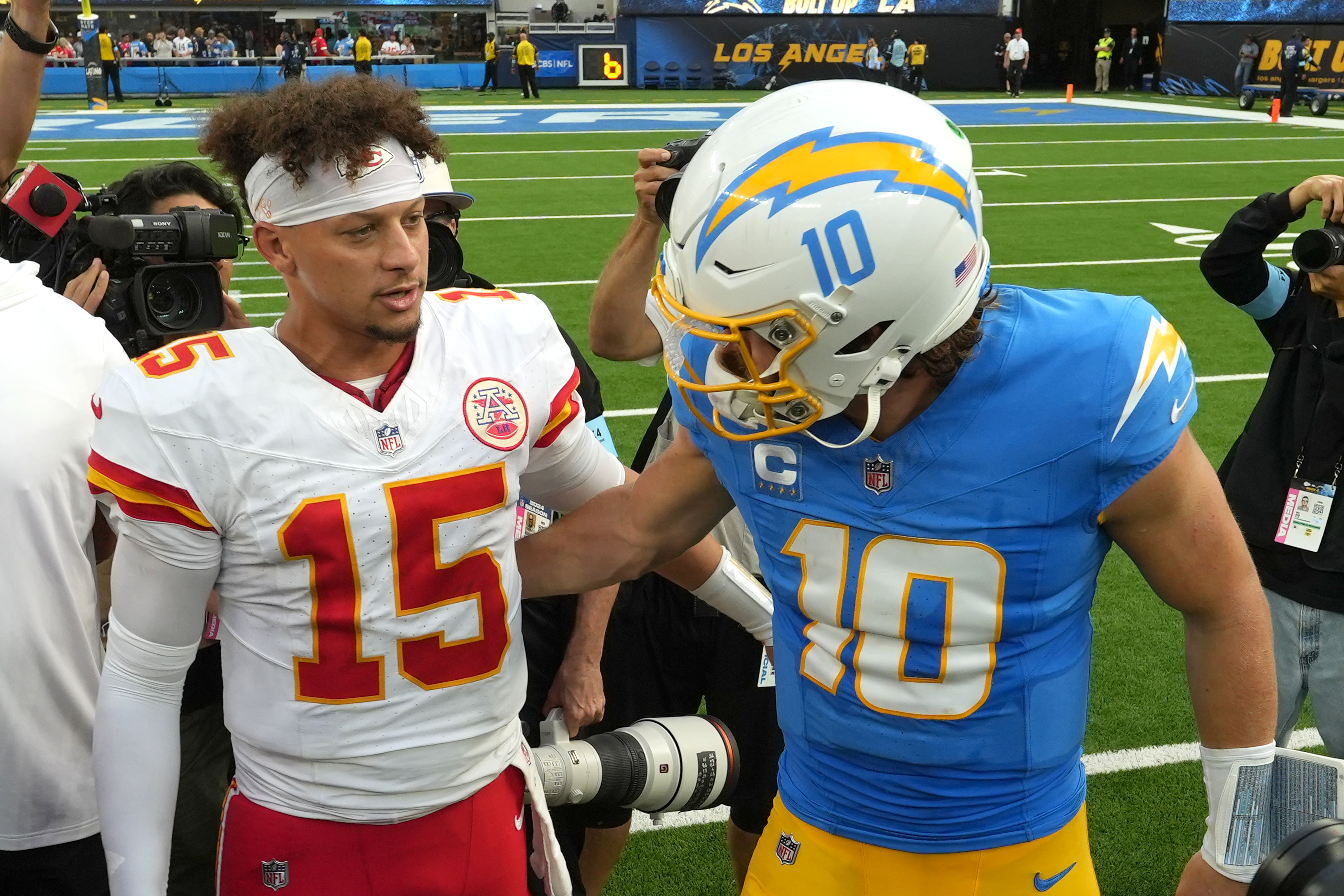 Kansas City Chiefs quarterback Patrick Mahomes (15) and Los Angeles Chargers quarterback Justin Herbert (10) shake hands after the game at SoFi Stadium.