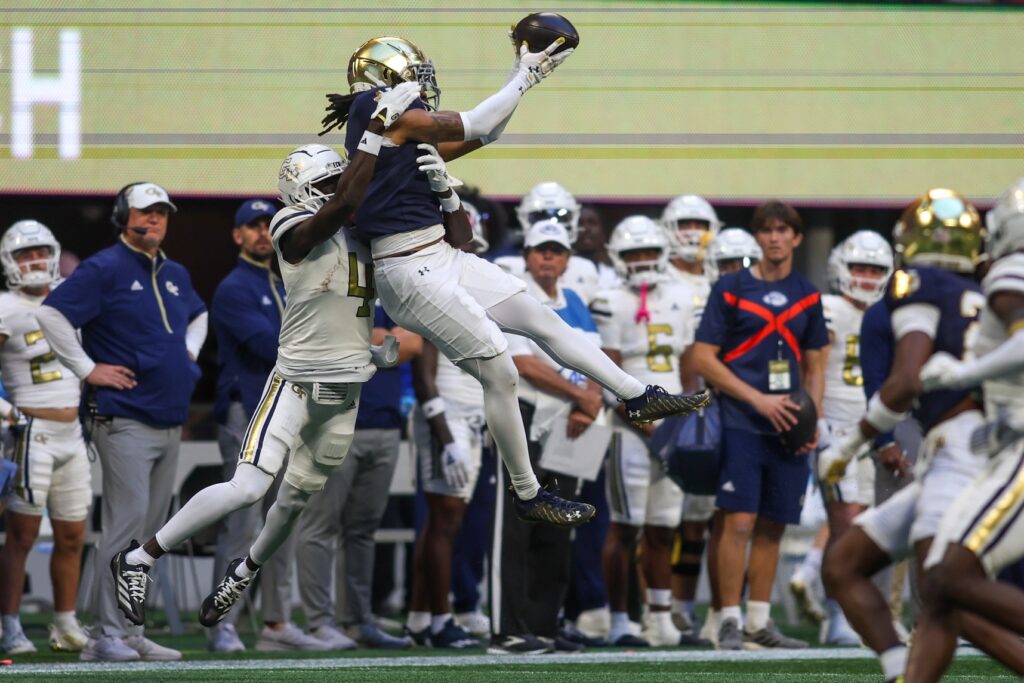 Notre Dame Fighting Irish safety Xavier Watts (0) intercepts a pass in front of Georgia Tech Yellow Jackets wide receiver Abdul Janneh Jr. (4) in the fourth quarter at Mercedes-Benz Stadium. Brett Davis-Imagn Images.