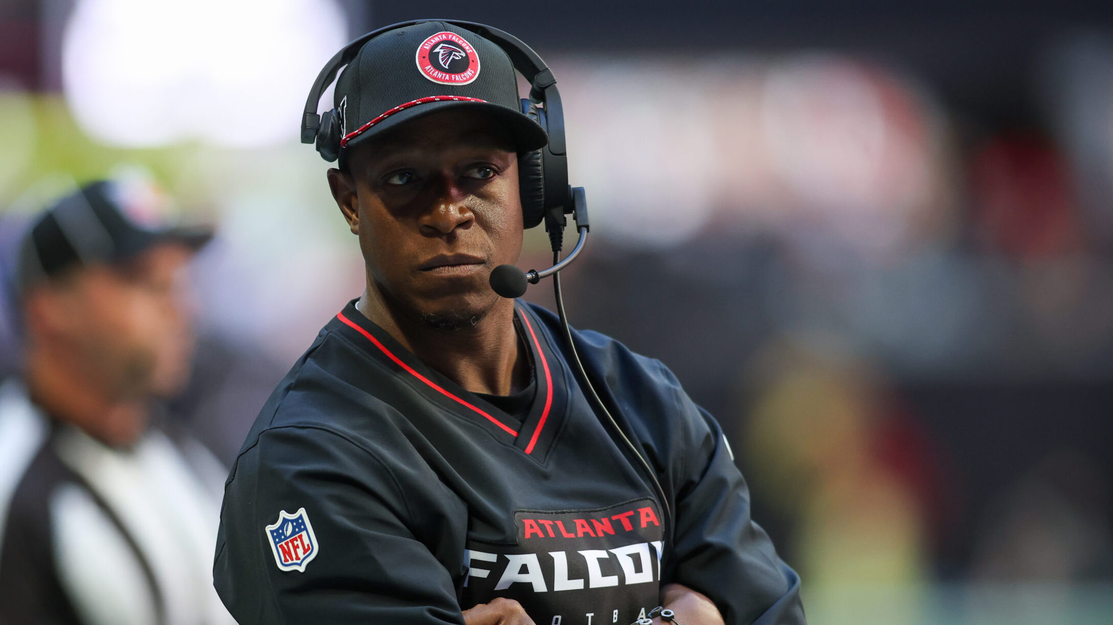 Falcons coach Raheem Morris stands on the sideline with his arms crossed