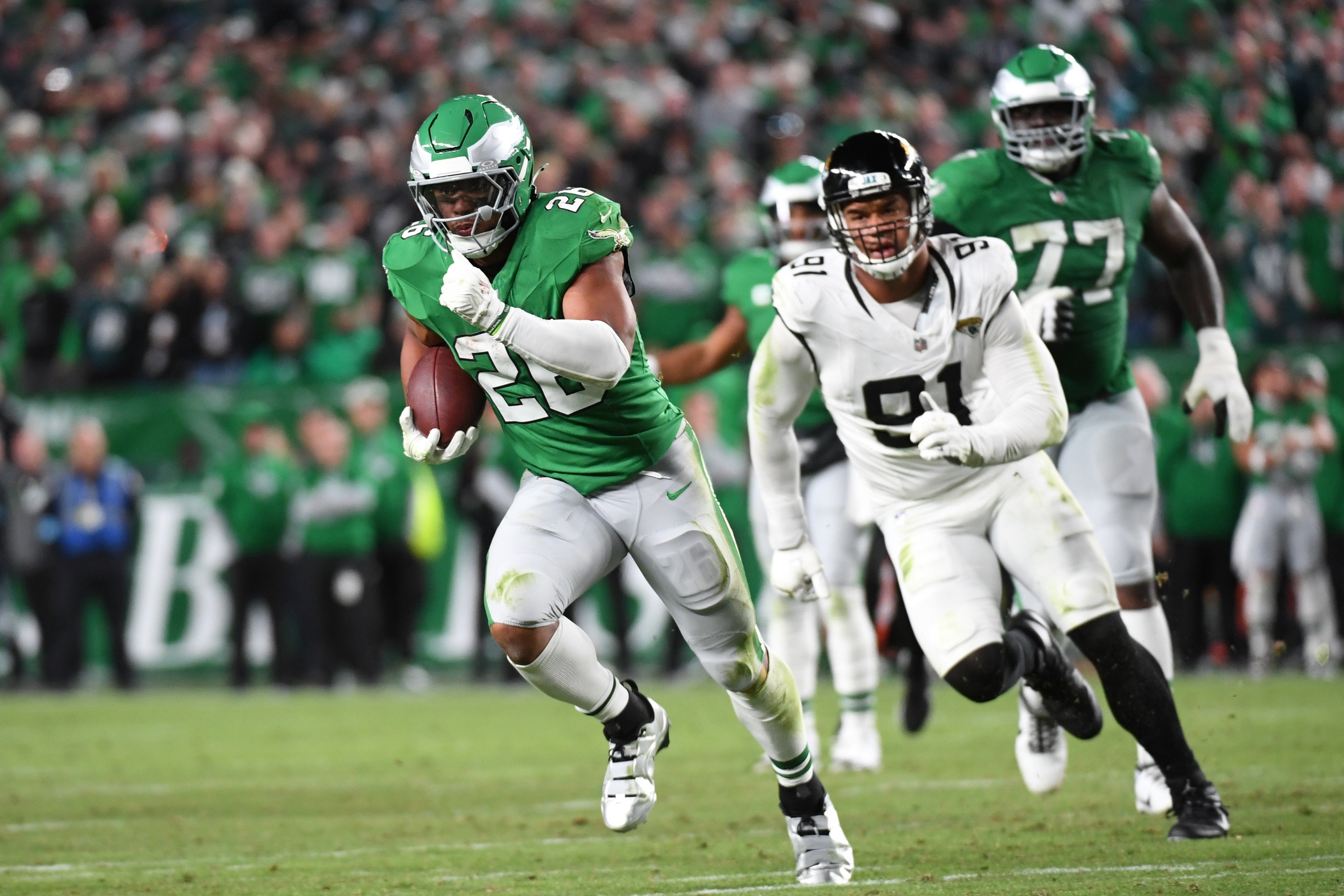 Philadelphia Eagles running back Saquon Barkley (26) runs past Jacksonville Jaguars defensive end Arik Armstead (91) on a 19-yard touchdown run during the second quarter against the Jacksonville Jaguars at Lincoln Financial Field.