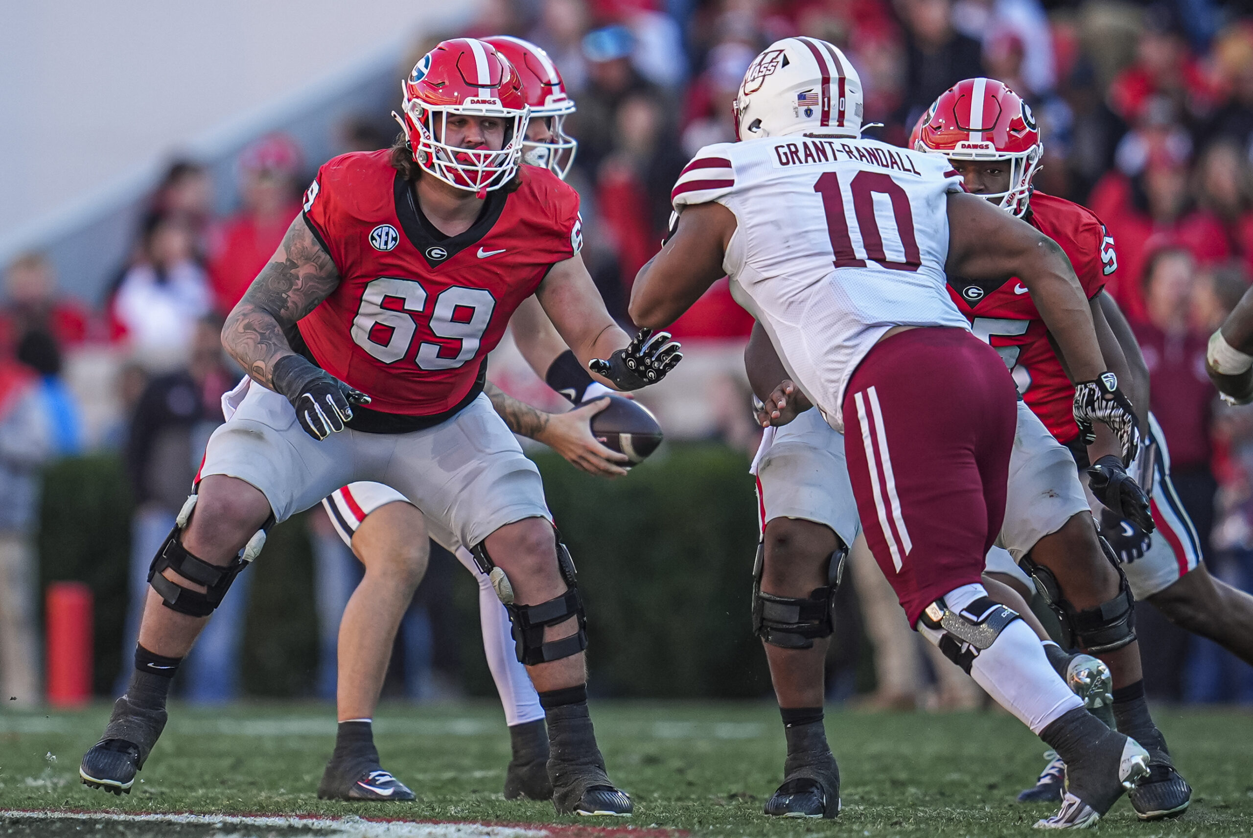 Georgia Bulldogs offensive lineman Tate Ratledge (69) blocks against Massachusetts Minutemen defensive end Zukudo Igwenagu (10) during the second half at Sanford Stadium.