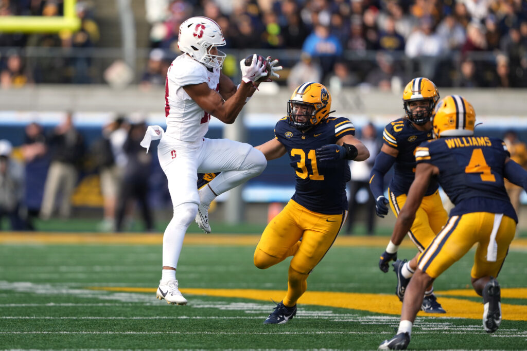 Stanford Cardinal wide receiver Elic Ayomanor (left) catches a pass against California Golden Bears linebacker Hunter Barth (31) during the third quarter at California Memorial Stadium. 