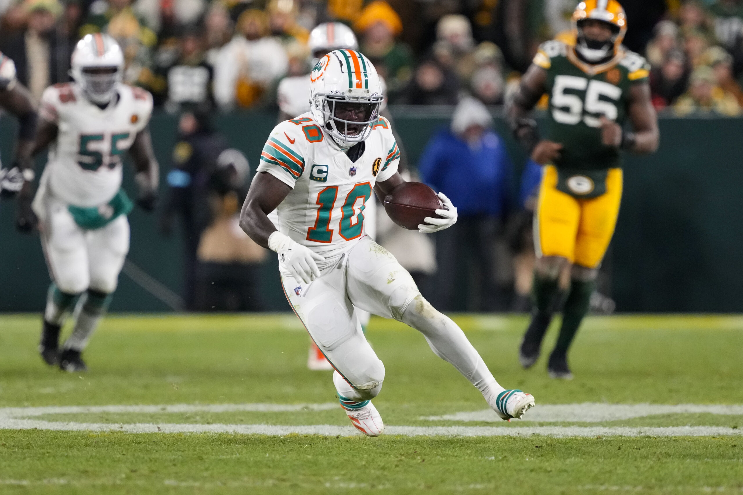 Miami Dolphins wide receiver Tyreek Hill (10) rushes with the football during the fourth quarter against the Green Bay Packers at Lambeau Field.