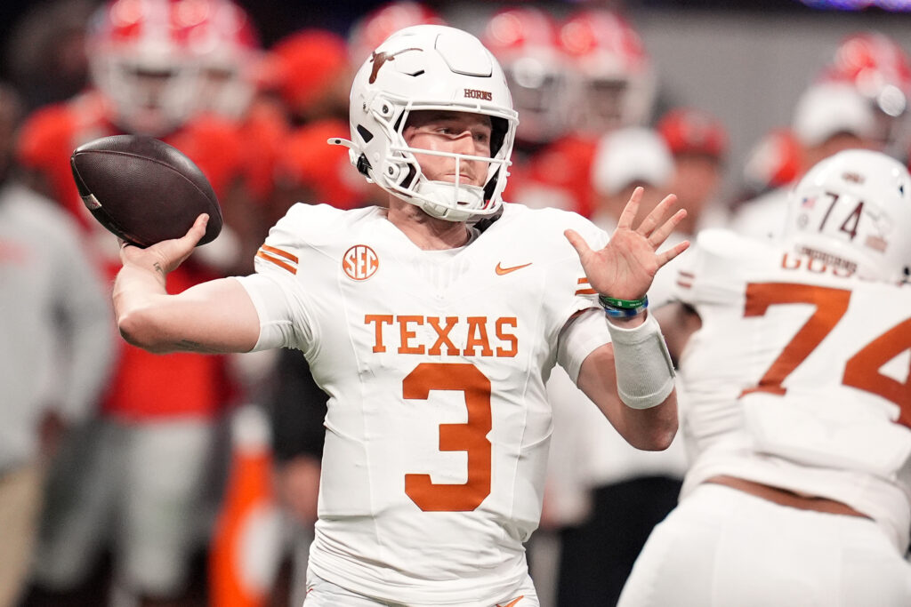 Texas Longhorns quarterback Quinn Ewers (3) drops back to pass against the Georgia Bulldogs during the first half in the 2024 SEC Championship game at Mercedes-Benz Stadium.